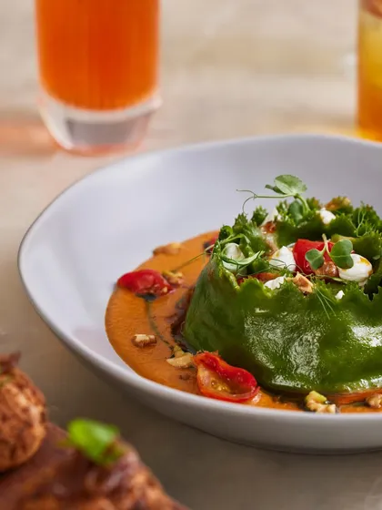 Our Spinach and Ricotta Crown Ravioli is a true signature. The pasta is handmade, of course, nestled in a charred tomato and miso sauce with toasted walnuts and goat's cheese for a hearty, comforting bowl.