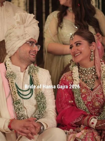 A sweet, candid moment between the bride and groom. Their smiles and the way they look at each other tell a story of love, with her mehendi as a beautiful backdrop.