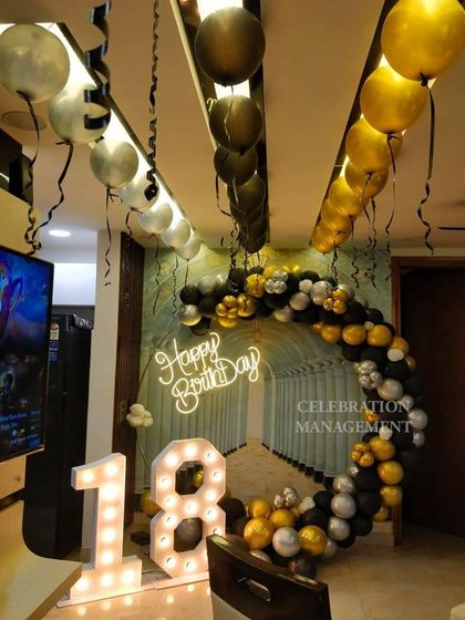This view shows how the entire room was decorated to match the backdrop, with balloons on the ceiling creating a cohesive party atmosphere.