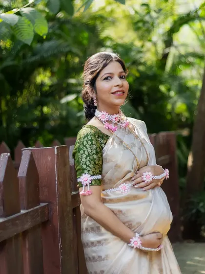 A lovely portrait of an expecting mother cradling her baby bump. Her serene expression and the soft, natural light make this a timeless maternity photograph.