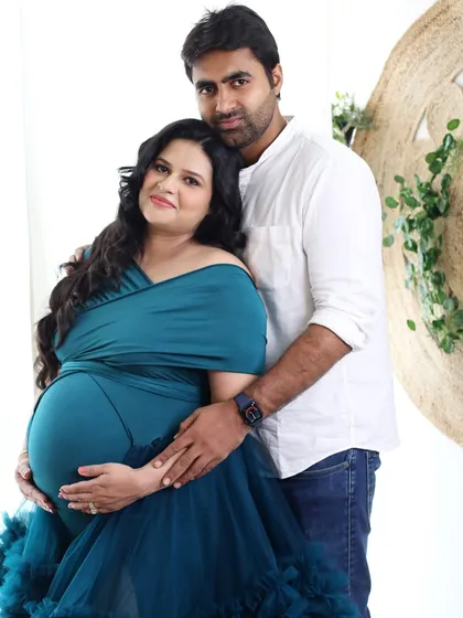 Waiting for their little one together. This classic couple portrait against our boho backdrop captures the supportive and loving bond between the partners.