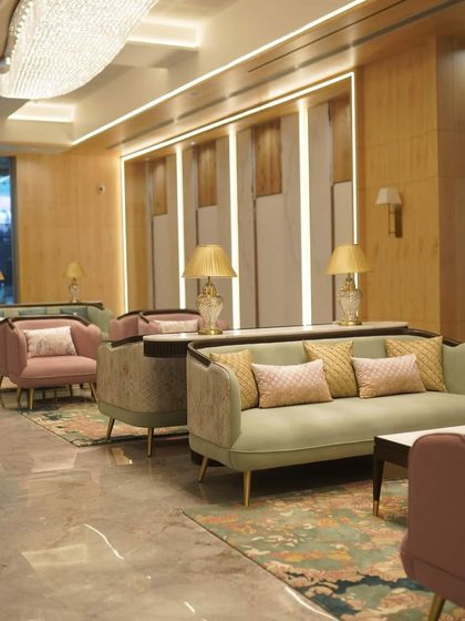 The lobby of the GCC Hotel and Club, featuring our soft green and dusty rose upholstery. The combination of colors, textures, and our custom carpet design creates a warm, luxurious, and inviting ambiance for guests.