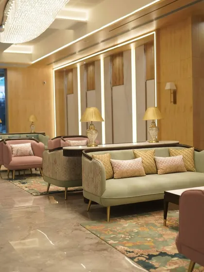 A seating area in the GCC Hotel lobby, where I used a mix of pastel green and pink upholstery. The custom-designed sofas and armchairs are complemented by elegant lighting and patterned cushions.