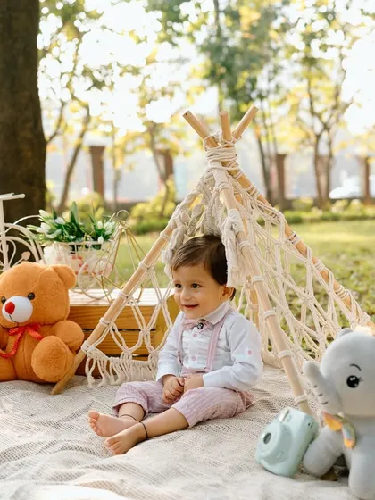 Another angle from the baby picnic shoot, showing the thoughtful details of the setup, from the miniature camera prop to the soft blanket and teddy bears.