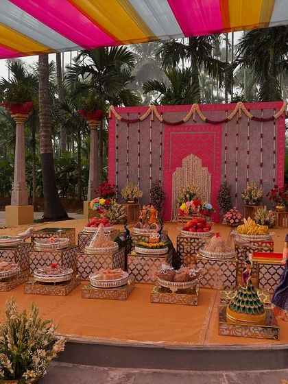 A wider view of the colorful outdoor stage, showing the surrounding palm trees.