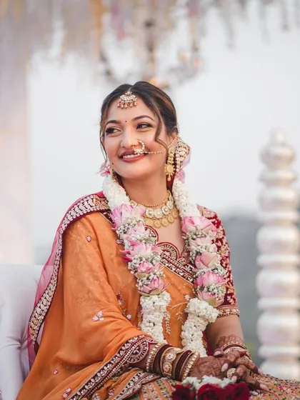 A beautiful moment during the ceremony. Her hair is adorned with a garland, and the updo holds perfectly, looking graceful and elegant.