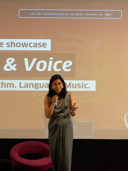 A mentor and poet guides participants during the 'Verse & Voice' performance showcase. Our mentors are deeply invested in the growth of each artist.