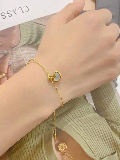 My adjustable heart slider bracelet with a mother-of-pearl inlay. The sliding bead allows for a perfect fit on any wrist.