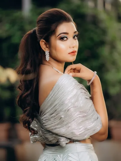 A graceful portrait of the bride looking over her shoulder. Her pose is elegant, and the soft background helps to make her the complete focus of the image.