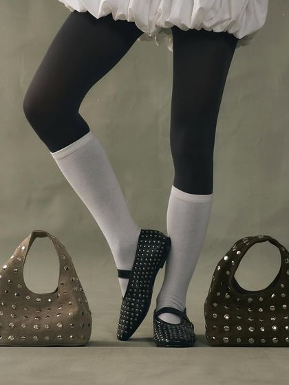 My signature studded edit, featuring ballet flats and cutout bags. This look is about coordinated edge, where the repetition of the silver rivets creates a cohesive and powerful style statement.