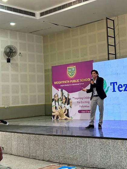 The stage is my classroom. Here I am at the Brightpath Public School event, with our TezzDimag branding prominently displayed. We partner with schools to bring our unique learning methods directly to students.