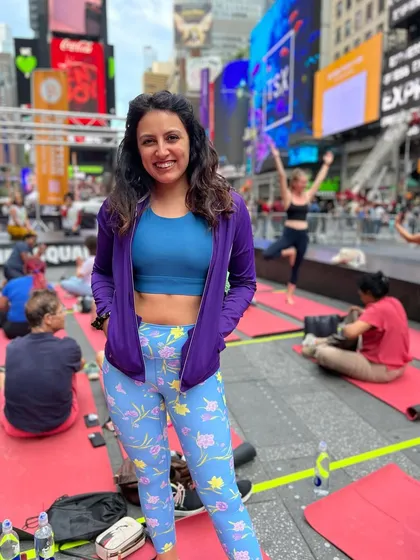 A smile after finding a moment of calm. This photo captures the unique experience of participating in a massive outdoor yoga session in Times Square.