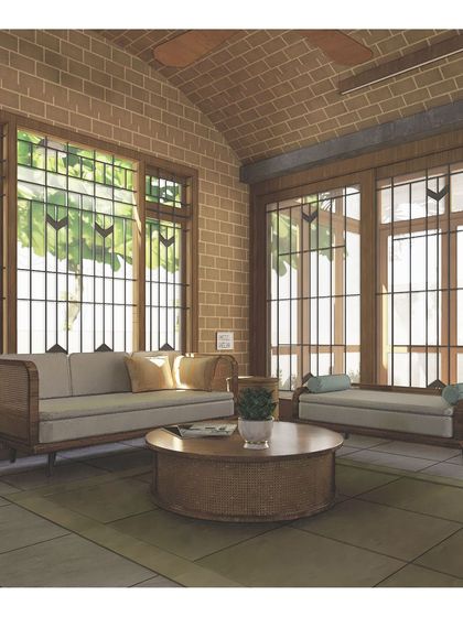 An illustration of the 'Nirupama' living room, focusing on how sunlight filters through the large windows to create a warm, cozy atmosphere.