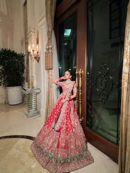 A full-length view of the bride, showing how the makeup, hair, and outfit come together. The makeup is designed to complement the grandeur of the lehenga, not compete with it.