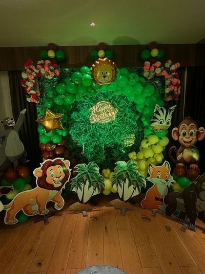Welcome to the jungle! This immersive jungle theme decoration featured a lush green backdrop and an array of friendly animal cutouts like lions, monkeys, and elephants. The green balloon arch made it feel like you were stepping right into a wild adventure.