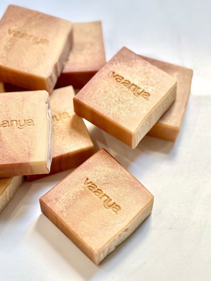 A pile of our custom sunset-themed soaps, each stamped with our brand name. These were created especially for the festive season.