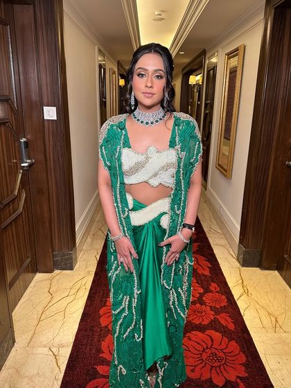 A bohemian-inspired half-updo with soft waves and small, decorative gold accessories. This look is perfect for a Mehendi or a relaxed, outdoor event.