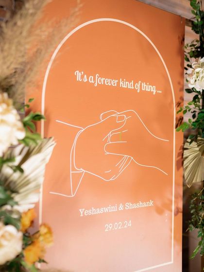 "It's a forever kind of thing." A custom welcome sign we designed for Yeshaswini and Shashank's engagement. The simple line art and warm terracotta color perfectly captured the modern, romantic vibe of their celebration.