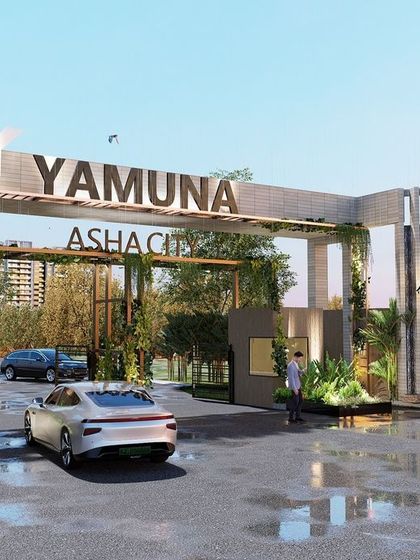 The grand entrance gate for the Yamuna Asha City development. The design uses clean lines, integrated planters with climbing greenery, and prominent branding to create a modern and inviting gateway that sets a premium tone for the entire community.