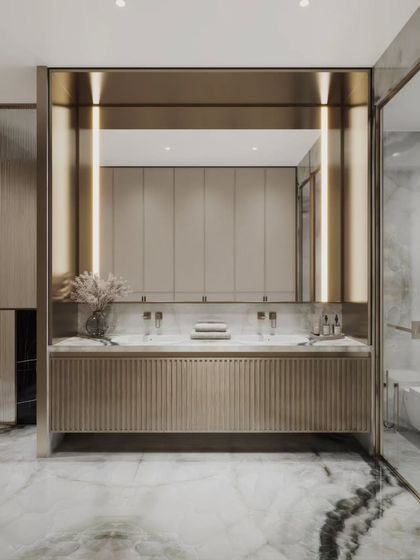 Two views of a sleek, modern bathroom featuring a long vanity with fluted details and warm, integrated lighting. Our renders highlight the beautiful contrast between the veined marble floor and the matte gold and beige finishes.