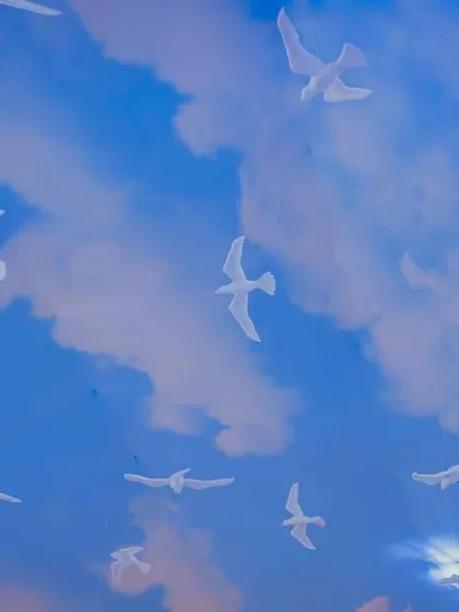 The ceiling of the nautical-themed venue was painted to look like a bright blue sky with fluffy clouds and soaring seagulls, completing the open-sea illusion.