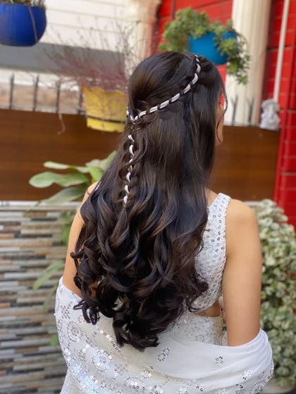 A braided half-up look for a Roka ceremony. The delicate silver braid adds a beautiful detail to the soft waves.
