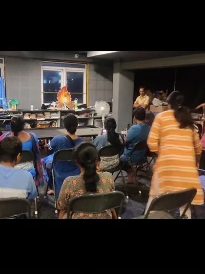 The audience of parents watches the final puppet show, which was conceptualized and performed entirely by the children based on their art installations.