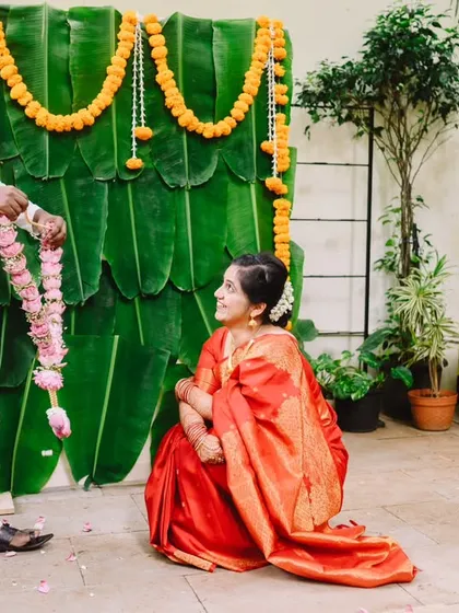 A beautiful, traditional moment during Nikita and Dnyanratna's wedding. The groom offers the garland to the seated bride, a lovely ritual full of respect and love.