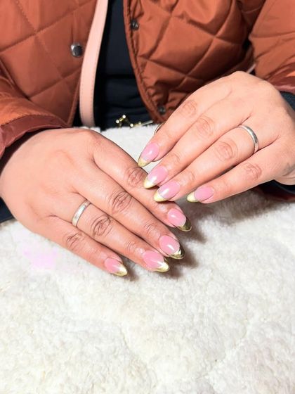 A simple French manicure with a twist, featuring a lime green chrome tip on almond-shaped nails.