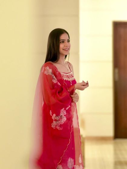 A candid, smiling shot that brings a warm and approachable feel to the outfit.