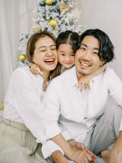 A happy family hug in front of the Christmas tree. The genuine joy and love are what make the holidays so special.
