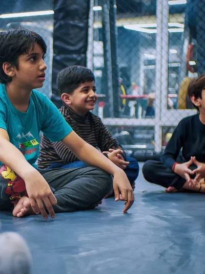 The look of complete focus. These students are absorbed in their coach's instruction, a skill that translates directly to better performance in school and other areas of life.