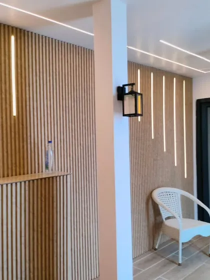 Another view of the terrace room interior, showing the clean lines of the design, integrated ceiling lights, and wall-mounted lanterns for added ambiance.