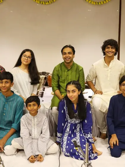 This is my wonderful group of students after our Gurupoornima concert. We foster a supportive and friendly environment where students of all ages, from young children to teenagers, learn and grow together as musicians.