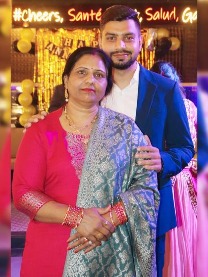 A portrait of a son with his arm around his mother, captured at a family gathering.