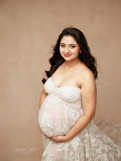 A sweet and simple portrait in a strapless white lace gown, capturing a gentle smile and the beautiful texture of the fabric.