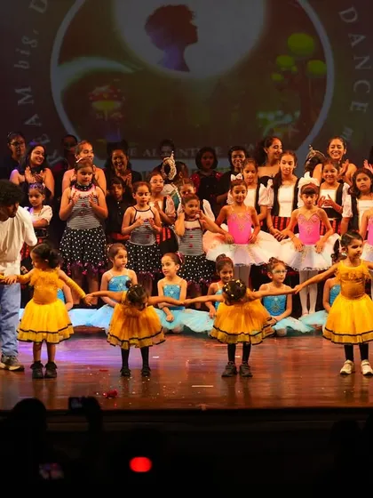 Guiding our youngest performers on stage. We ensure every child feels supported and confident during their first stage experience, creating a positive and memorable moment.