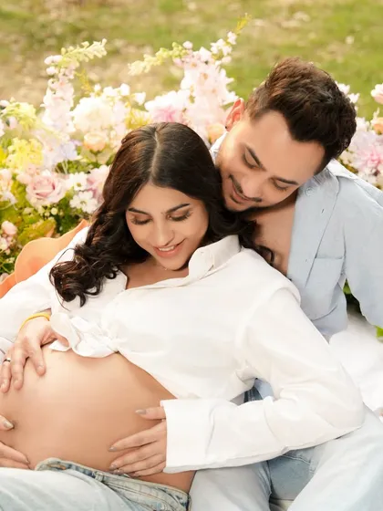 An outdoor picnic setup for Pria and Millind, surrounded by a field of flowers. This shows how we can create a beautiful, relaxed atmosphere for your shoot.