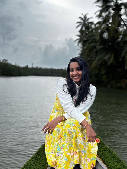A traveler enjoying a serene boat ride through the mangrove forests of Honnavara.
