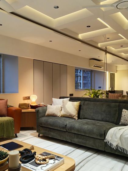 This view highlights the L-shaped sofa and the indoor swing, two elements that make this living room perfect for family gatherings and relaxation.