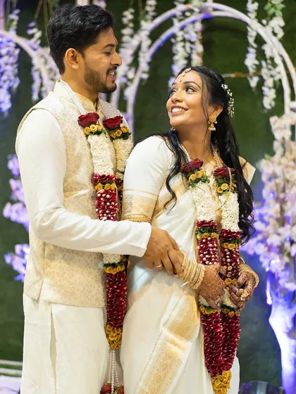 A lovely and happy couple from a Christian wedding. The bride is dressed in a beautiful white and gold saree, with her makeup kept natural and elegant.