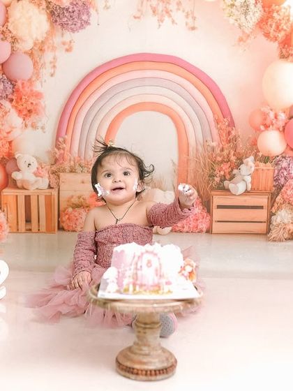 The pure delight of a first birthday cake smash. This image captures the joy and mess that makes these sessions so memorable.