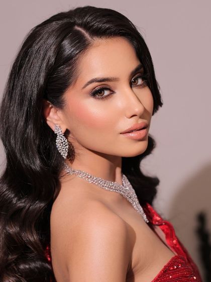 A side profile highlighting the beautiful smokey eye and soft, voluminous curls. This is a classic Hollywood glam look.