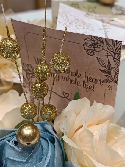 A detail shot of the engagement hamper, with glittery decorative elements and a heartfelt card.