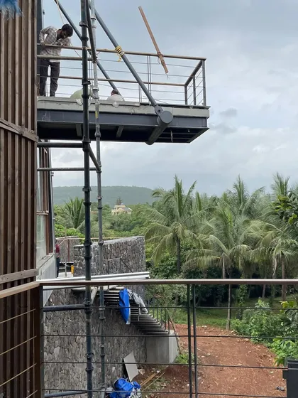 A view from the nearly completed cantilevered balcony at our Karjat project. The structure is designed to frame the stunning panorama of the valley, making the natural scenery an integral part of the living experience.