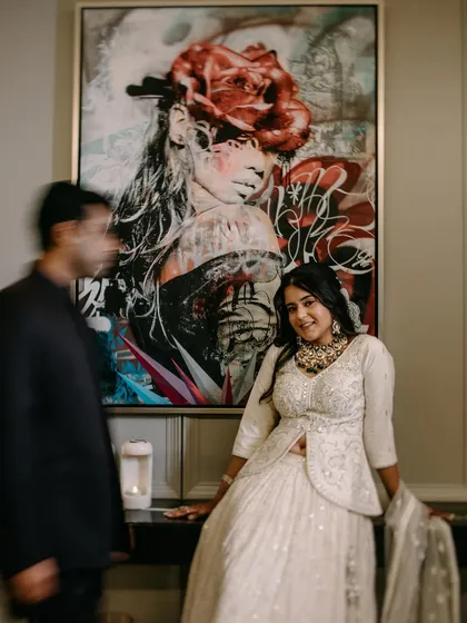 A creative shot using motion blur on the groom to draw focus to the bride. This artistic choice adds a dynamic element to an indoor portrait session.
