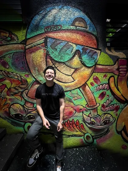 Posing in front of some cool graffiti art. I'm always inspired by the creativity around me, and I bring that into my work.