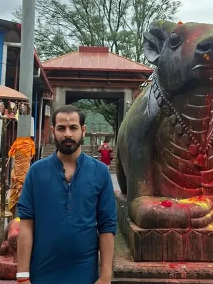 Standing beside the Nandi statue at Doleshwar Mahadev. This temple is consecrated, allowing devotees to get close to the deity and make offerings.