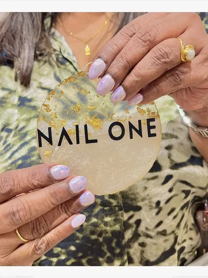 Even on shorter nails, a holographic finish makes a big impact. This client chose a beautiful iridescent polish that shifts in the light, proving that you don’t need long extensions for a statement look.