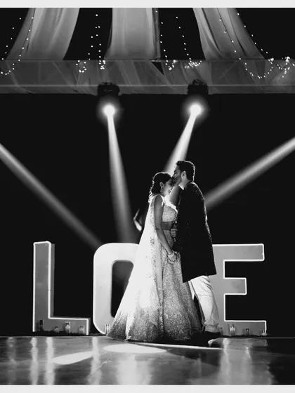 The same iconic "LOVE" sign shot, showcasing the couple's intimate moment. We design these picture-perfect spots for memories that will last a lifetime.